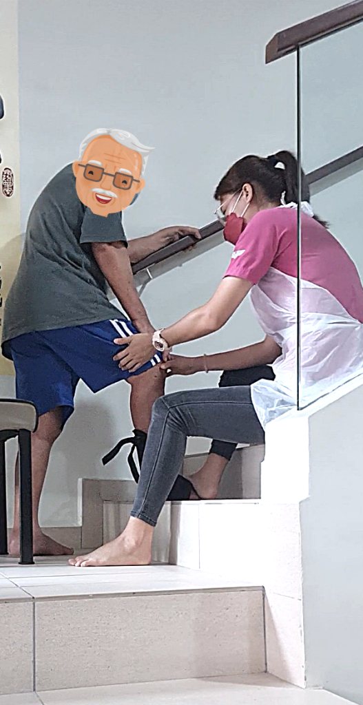 A therapist helping a patient practise stairs
